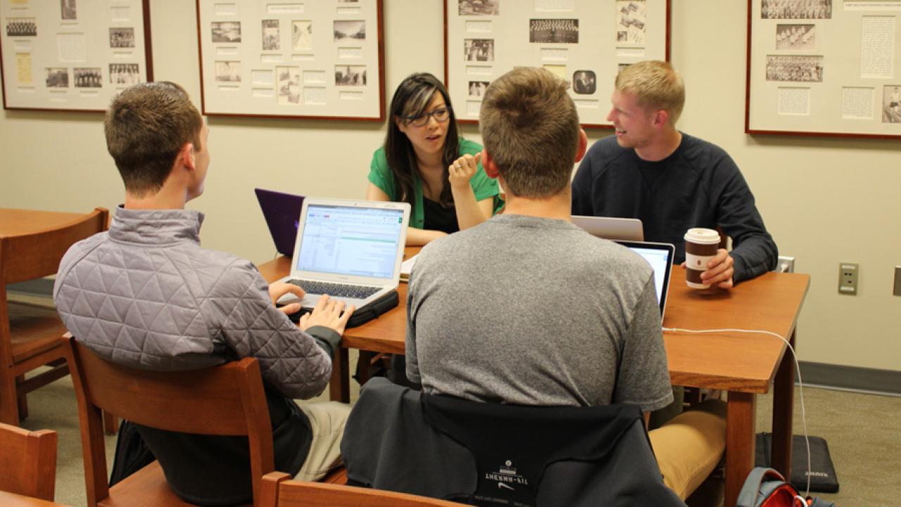 Professor Carolyn Ly-Donovan discusses research strategies with students.